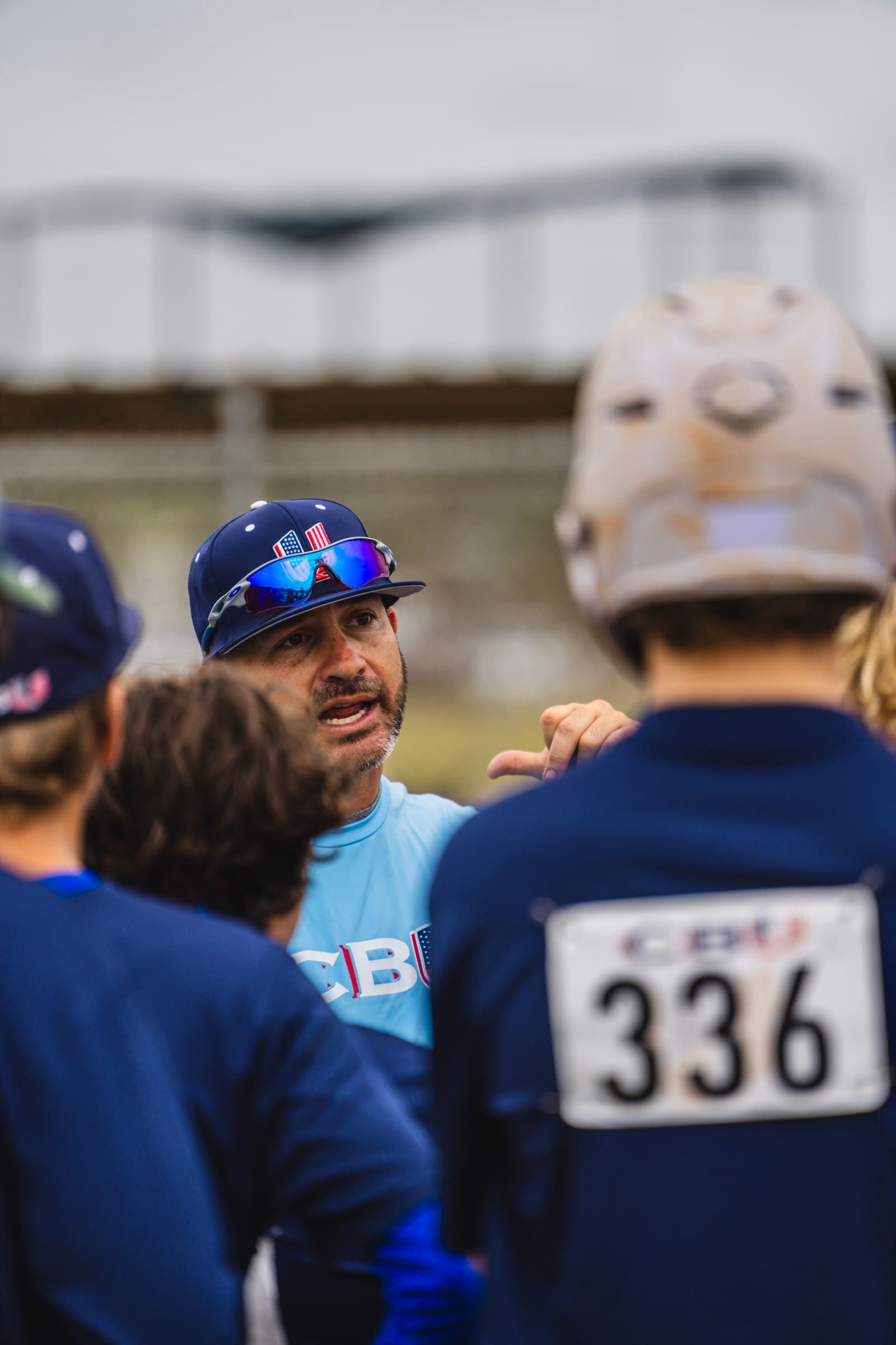 Coach speaking intensely to youth group during practice